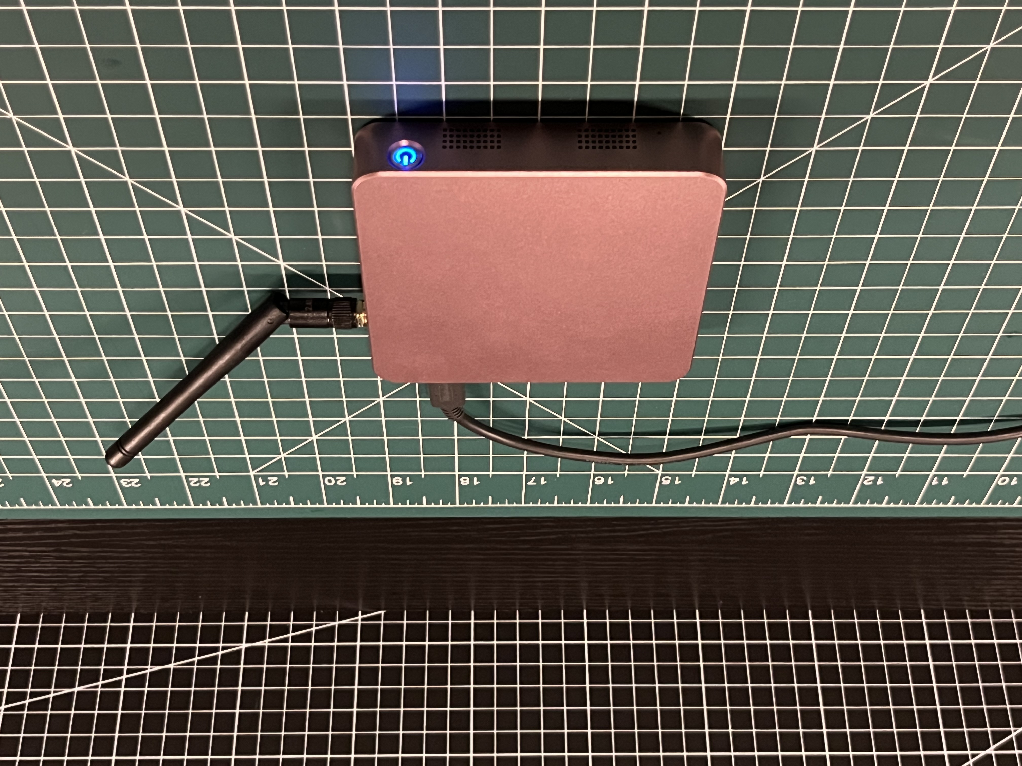 ED-CLAWBOX powered on with antenna attached and blue power button lit